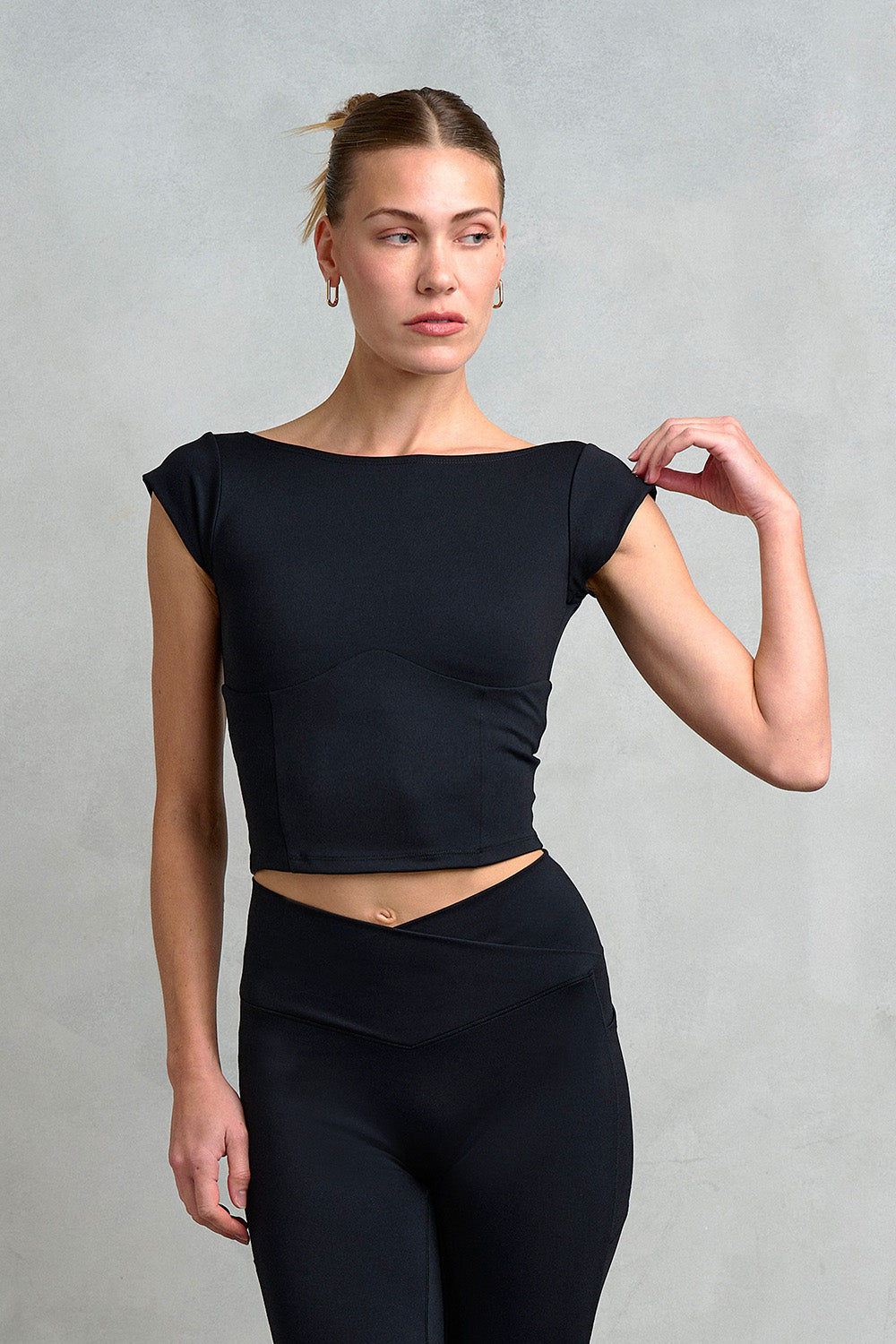 Our model is wearing the Camden square neck, backless top. Part of Stretch Studio London's new luxury athleisure collection, designed to take you from barre to brunch seamlessly.